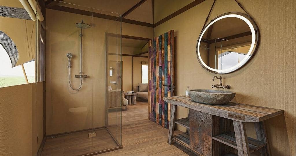 Rendering of the en-suite bathroom in the new Superior Double tent at Dolly Farm & River Camp: walk-in shower, stone basin and round mirror