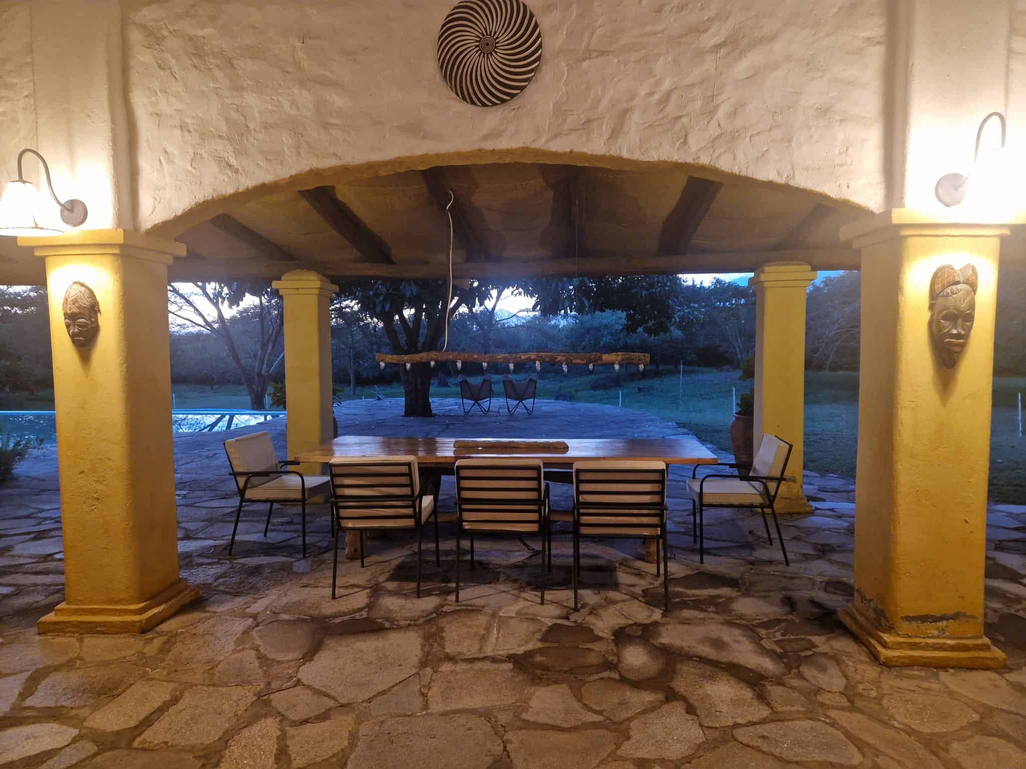 Covered dining terrace looking out to the garden – The Villa at Dolly Escape, Usa River, Tanzania